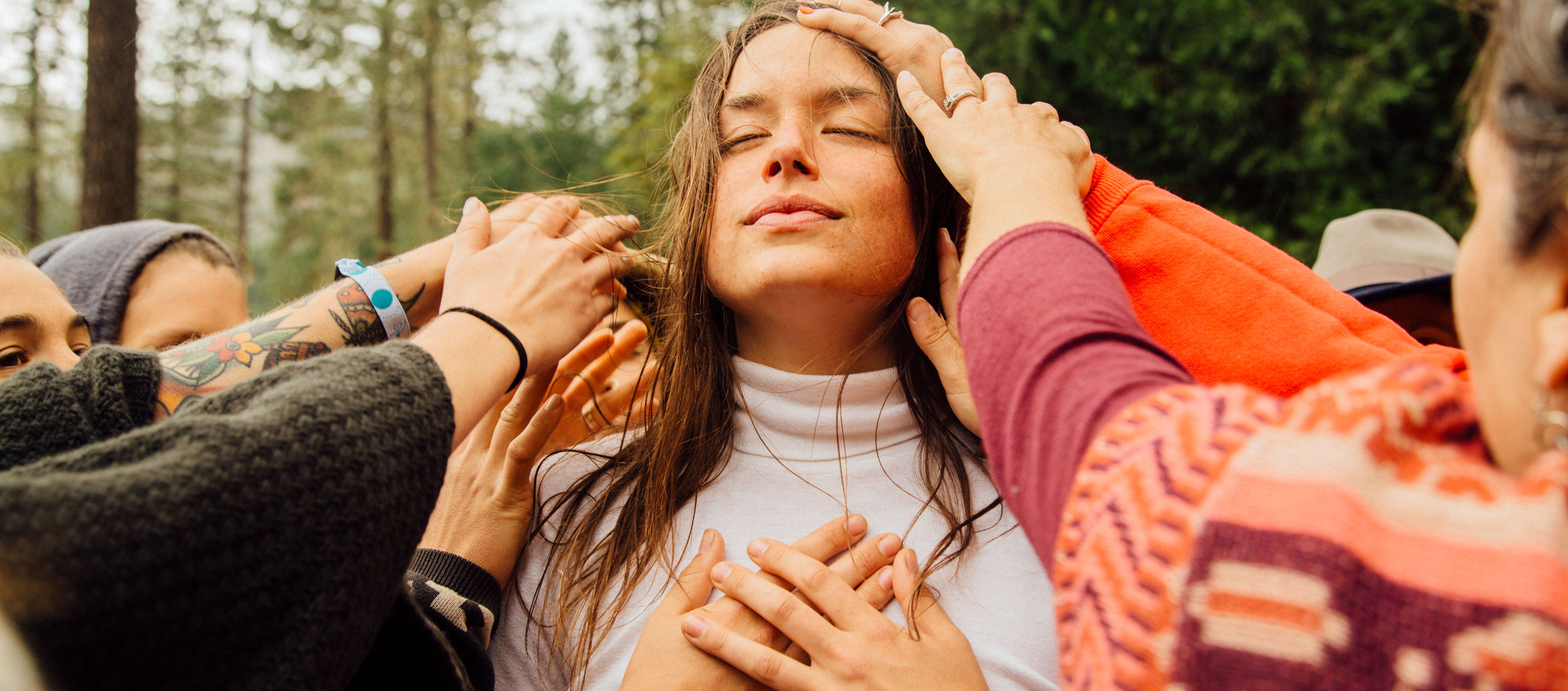women touching woman's head