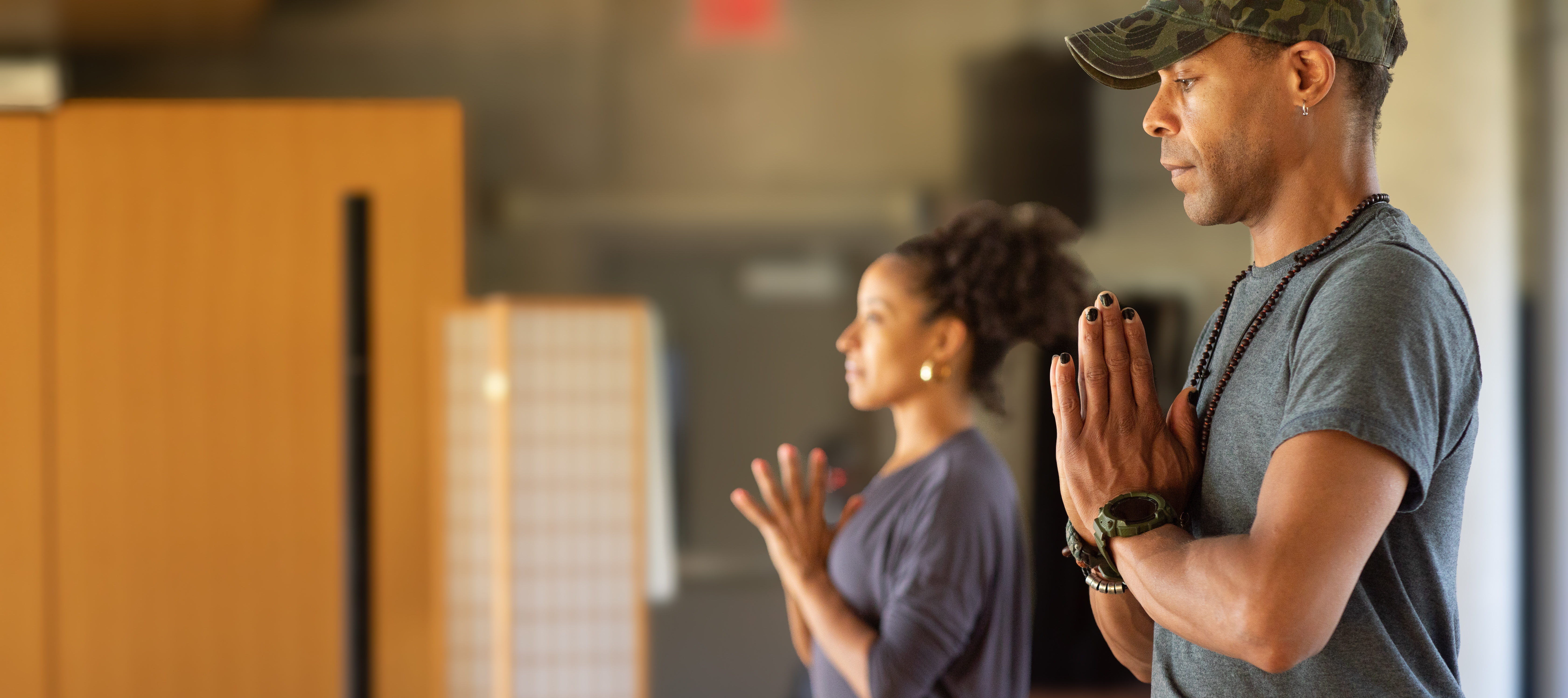 Healing the Root Two people of color practicing yoga and meditating
