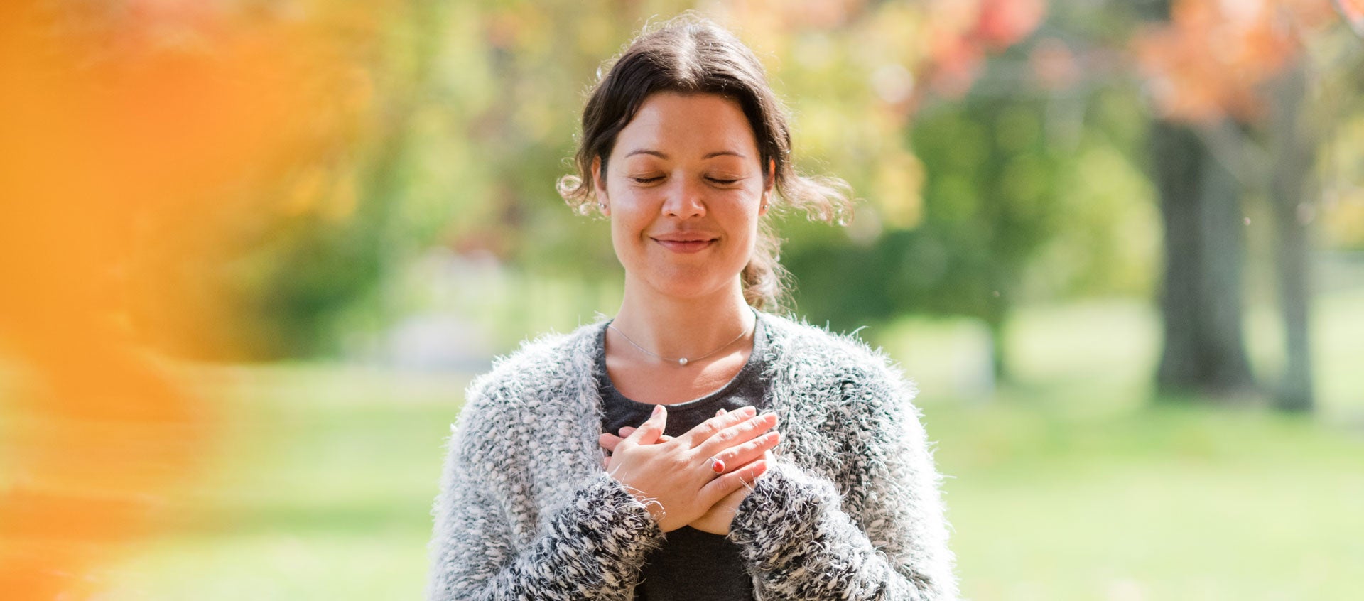 woman with eyes closed and smiling
