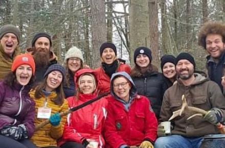 Group of smiling, exuberant people triumphant in the winter woods