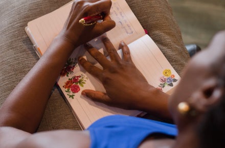 Black woman writing in a journal