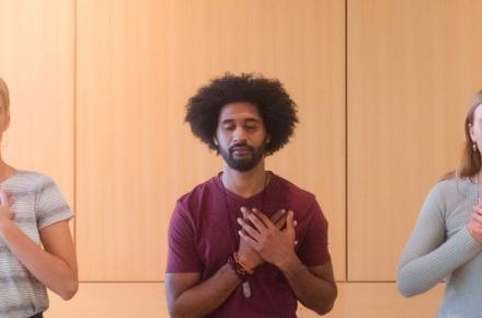 three people with hands over heart