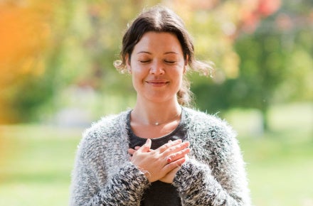 woman with eyes closed and smiling