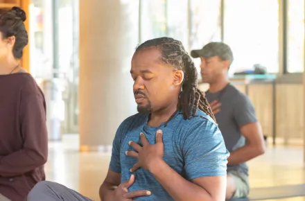 three people doing breathwork