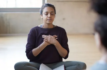 woman with hands on chest