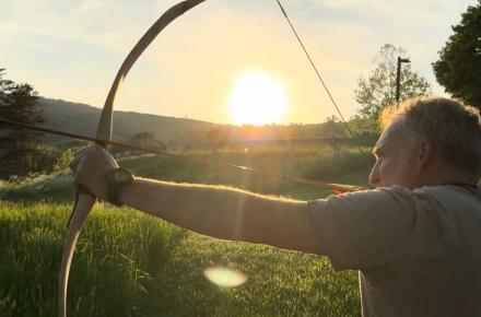 man practicing archery