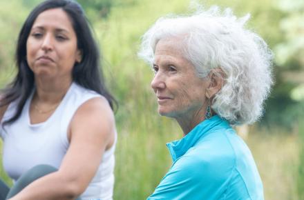 two women sitting outside