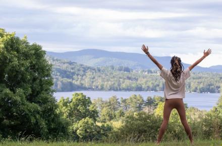 woman outside with arms outstretched
