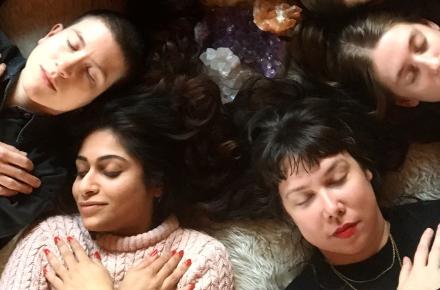 group of people lying down with eyes closed and arms crossed over their chest