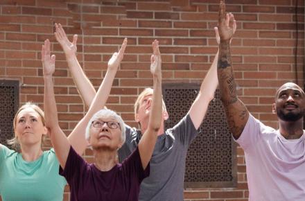 yogis with arms in the air