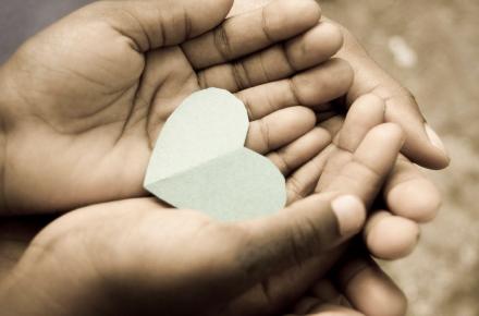 hands holding paper heart