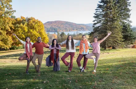 A group doing yoga outside in the fall
