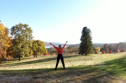 fall landscape with person holding up arms