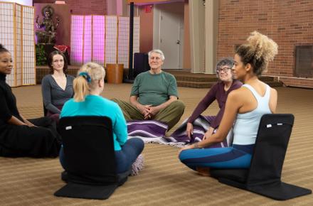 Group of people seated in a share circle