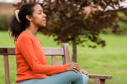 a person sitting on a bench outside