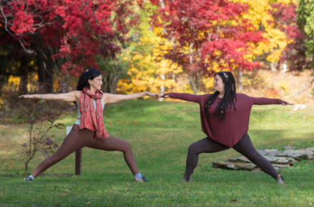 two people doing yoga outside