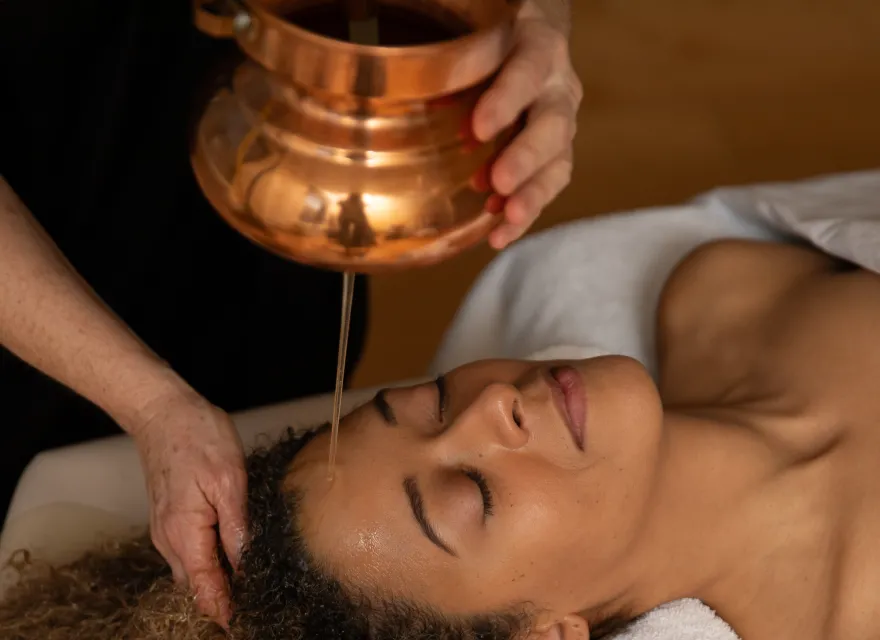 Woman receiving Ayurvedic oil treatment