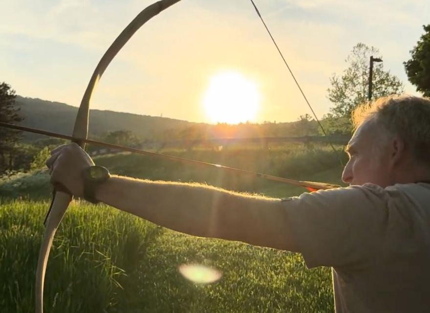 man practicing archery