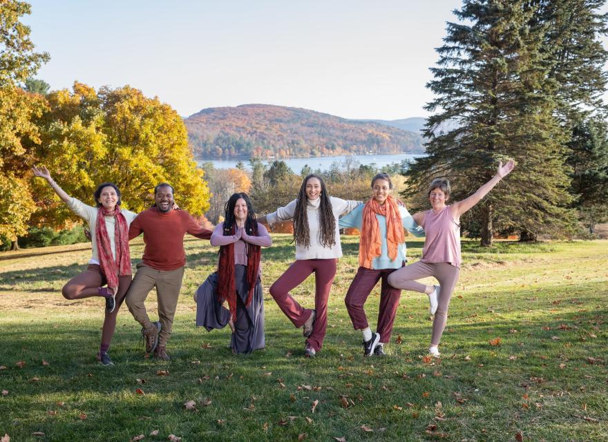 A group doing yoga outside in the fall