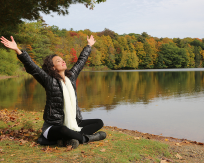 outside sitting by the lake in the fall