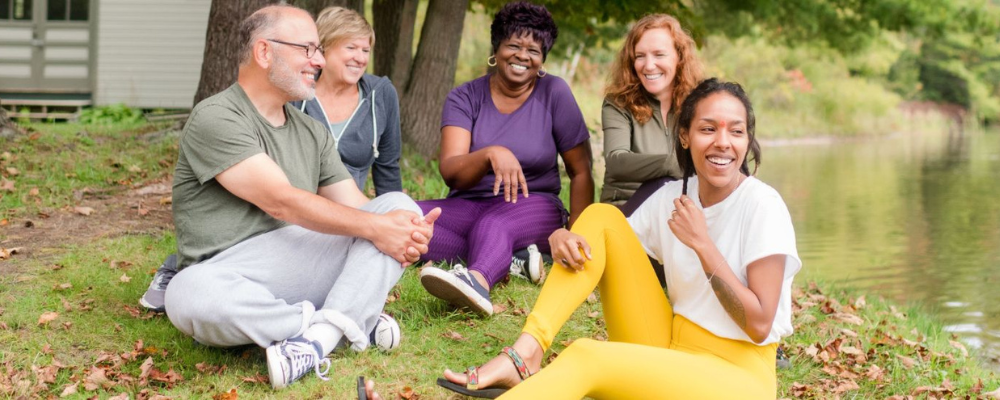 group sitting outside smiling