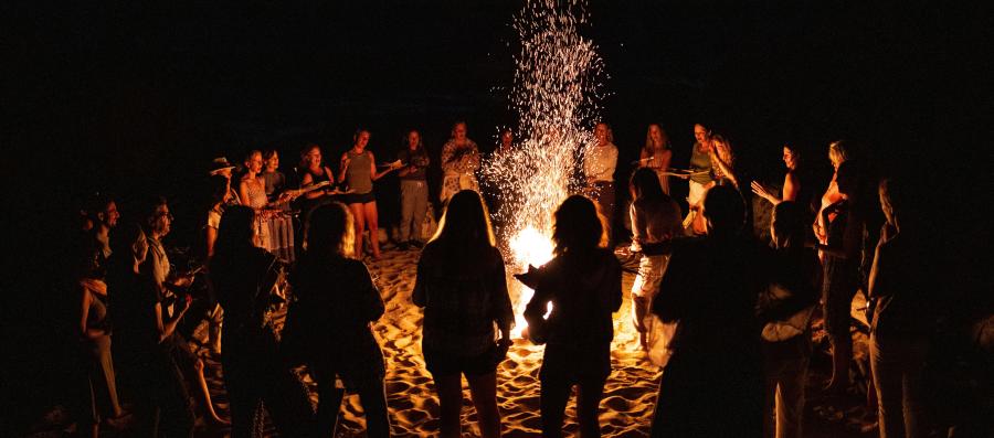 Group of people gathered around a bonfire