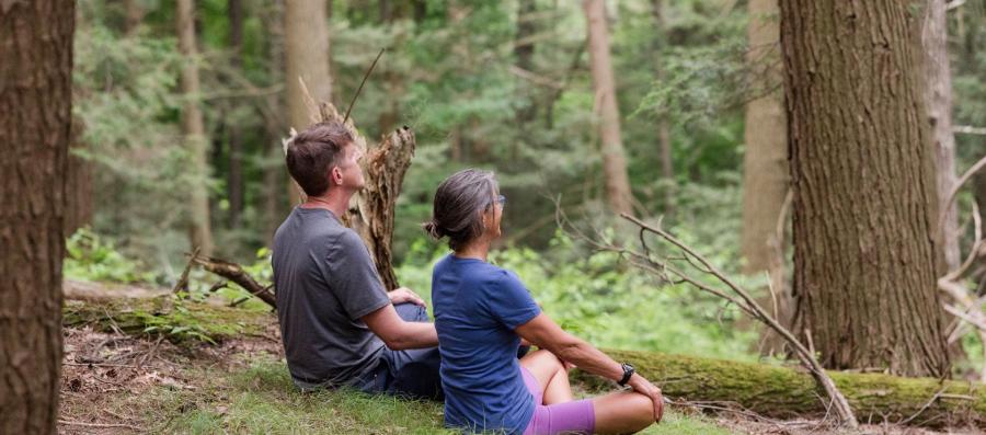 two people meditating outside