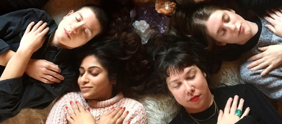 group of people lying down with eyes closed and arms crossed over their chest