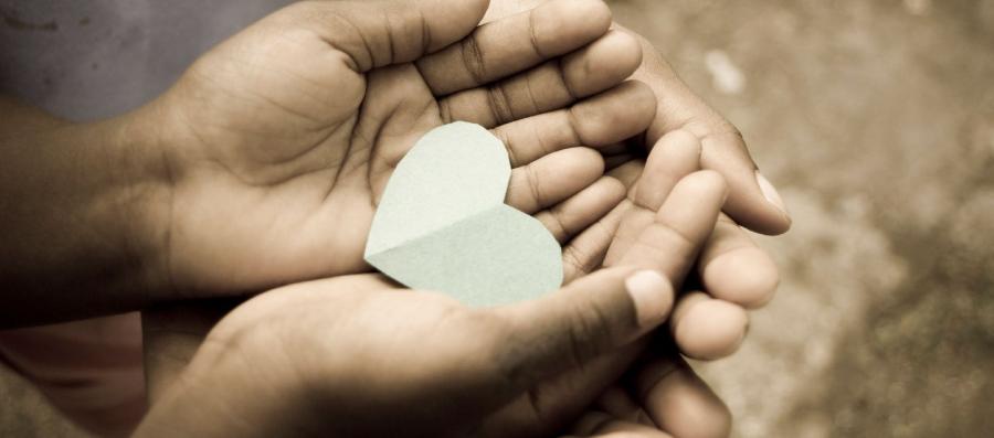 hands holding paper heart