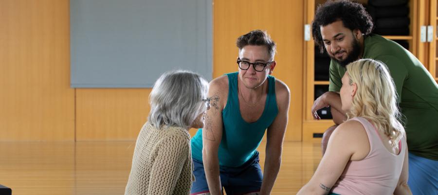 Diverse group of people talking during a yoga class