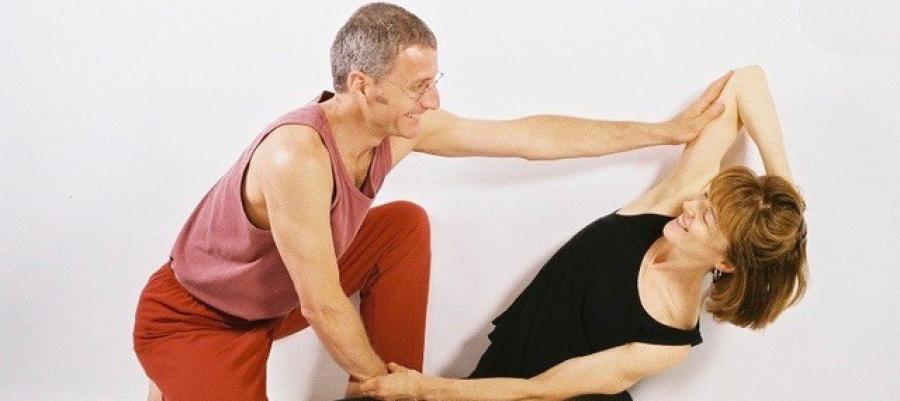 Daniel Lansky and a partner demonstrating assisted stretching