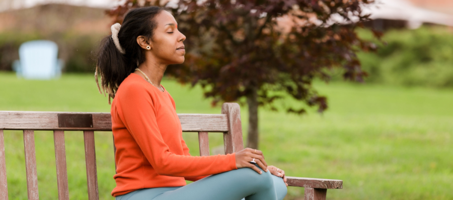 a person sitting on a bench outside