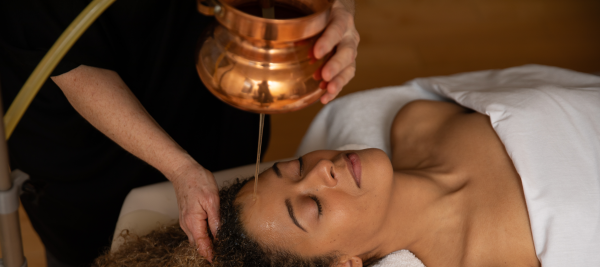 Woman receiving Ayurvedic oil treatment