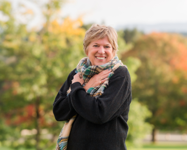 a woman outside in the fall foliage