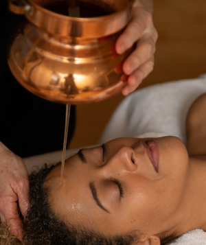 Woman receiving Ayurvedic oil treatment