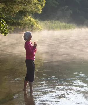 A woman with white hair standing in Lake Mahkeenac