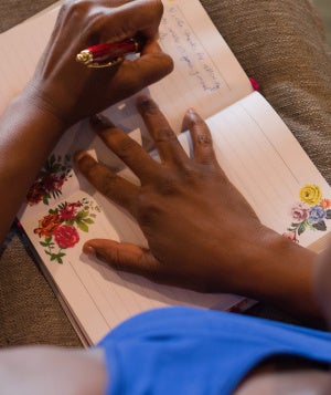 Black woman writing in a journal