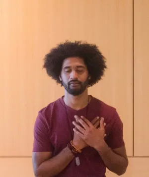 three people with hands over heart