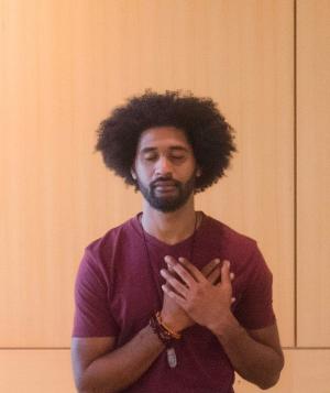 three people with hands over heart