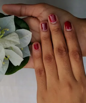 Two hands holding a flower