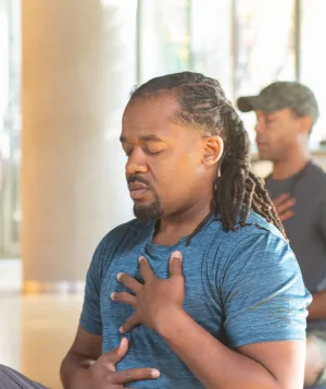 three people doing breathwork