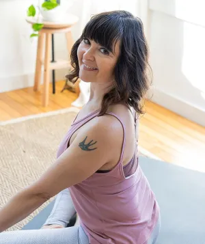 woman smiling on yoga mat