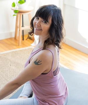 woman smiling on yoga mat