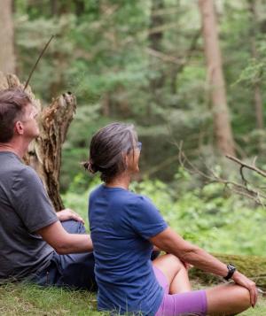 two people meditating outside