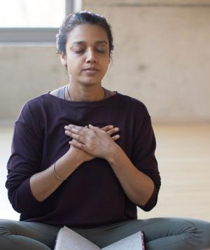 woman with hands on chest