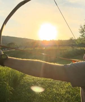 man practicing archery