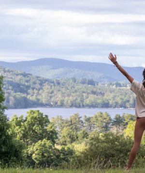 woman outside with arms outstretched
