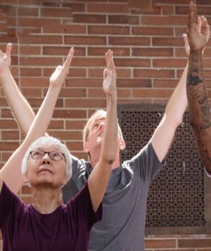 yogis with arms in the air