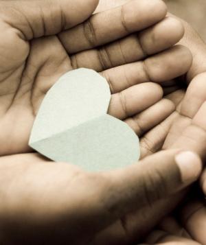 hands holding paper heart