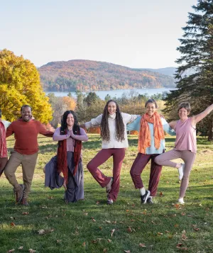 A group doing yoga outside in the fall